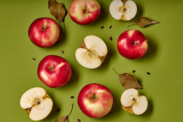 Fresh red apples and half. Isolated on green background. top view, copy space. flat lay. fruits, nutrition concept