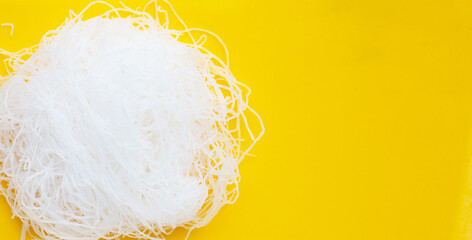 Vermicelli on yellow background. Top view