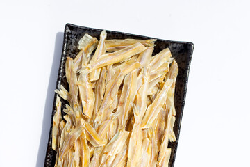 Dried anchovy on white background.