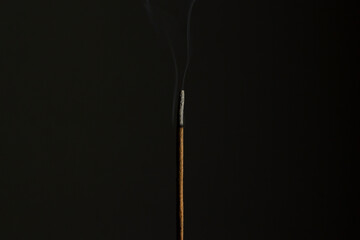 Fototapeta na wymiar Flame in incense stick burning in the dark