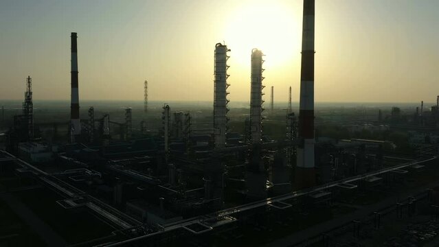 Oil Refinery. A column in rays of sun. Aerial view