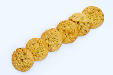 pistachio and almond cookies on white background.