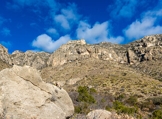 Fototapeta na wymiar Large Boulders and Rugged Mountains Along The Smith Spring Trail Near The Historic Frijole Ranch, Guadalupe National Park, Texas, USA