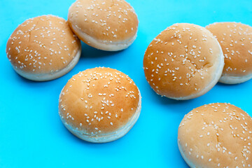 Hamburger buns with sesame on blue background.