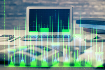 Financial graph colorful drawing and table with computer on background. Double exposure. Concept of international markets.