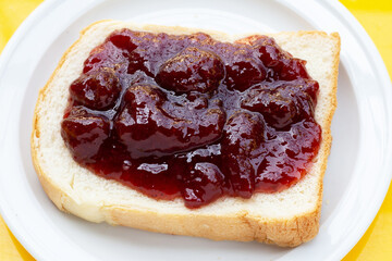 Sliced bread with strawberry jam