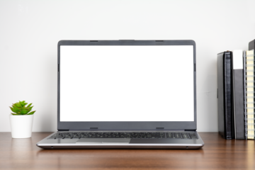 Home workplace with blank transparent screen laptop and books on wooden table with white wall background