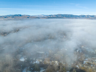 foggy winter morning over Rocky Mountains and Fort Collins, Colorado, aerial view