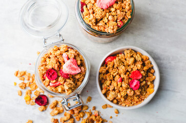 Fototapeta na wymiar Granola with Dried Berries on Bright Concrete Background, Healthy Vegan Snack or Breakfast
