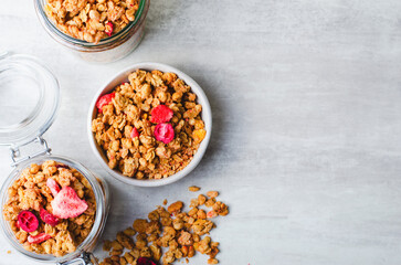 Obraz na płótnie Canvas Granola with Dried Berries on Bright Concrete Background, Healthy Vegan Snack or Breakfast