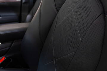 Luxury car inside. Comfortable leather seats. Cockpit in black perforated leather.