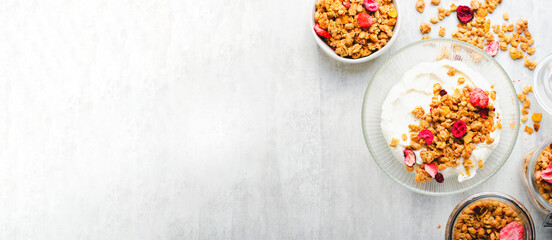 Granola with Yogurt in a Boal, Healthy Breakfast, Muesli with Dried Berries on Bright Concrete Background