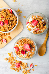Granola and Yogurt Parfaits, Healthy Breakfast or Snack, Muesli with Dried Berries on Bright Concrete Background