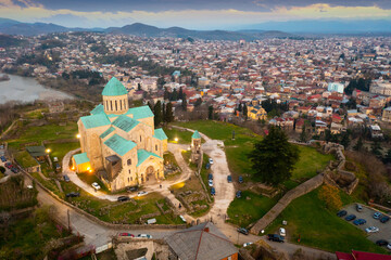Fototapeta na wymiar Aerial view of the ancient city of Kutaisi in the evening, located on the banks of the Rioni River, with a view of ..landmark Bagrati Cathedral