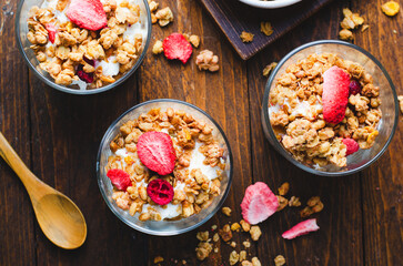 Granola and Yogurt Parfaits, Healthy Breakfast or Snack, Muesli with Dried Berries on Wooden Background