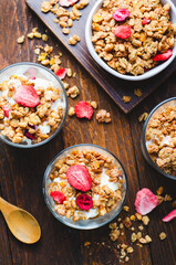 Granola and Yogurt Parfaits, Healthy Breakfast or Snack, Muesli with Dried Berries on Wooden Background