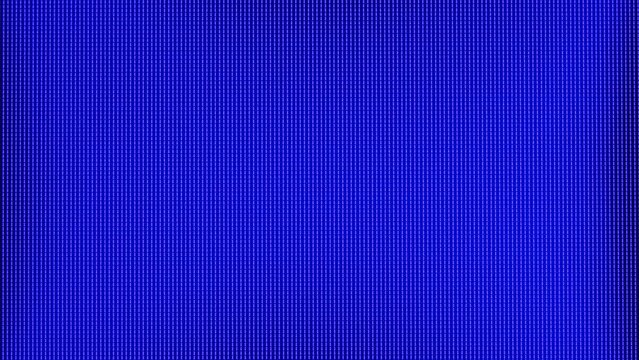 RGB multi-colored LEDs on the matrix of the TV close-up. Extreme macro view of 4K LED matrix red, blue, and green sub-pixels, monitor, or TV screen. Colored pixels texture creates an abstract pattern.