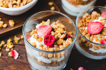 Granola and Yogurt Parfaits, Healthy Breakfast or Snack, Muesli with Dried Berries on Wooden Background