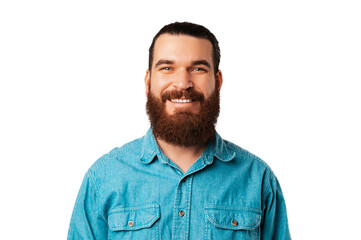 Obraz premium Portrait of a wide smiling young bearded man wearing blue jeans shirt.
