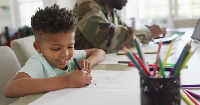 African american father with son learning together and writing