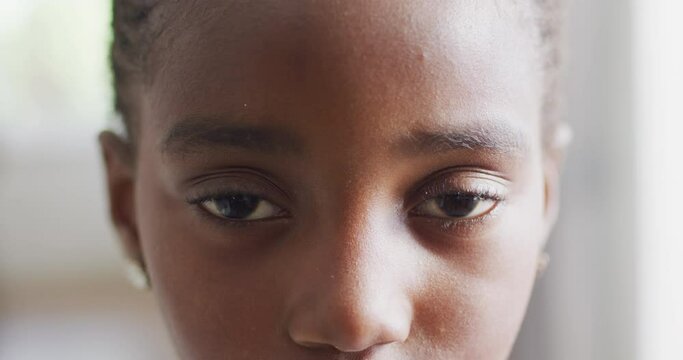 Video close up portrait of opening eyes of african american girl