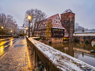 Fototapeta na wymiar Max Bridge, half timbered houses and the water tower at dusk in Nuremberg, Germany
