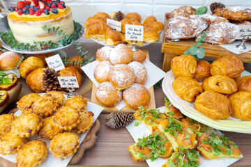table with a variety of trays containing different types of snacks. Sweet and salty food served on a table