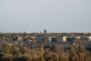 View of a small town, surrounded by forest and nature. City landscape.