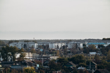 View of a small town, surrounded by forest and nature. City landscape.