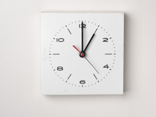 A clock on a white background. It is 1 o'clock. Concept, nobody.
