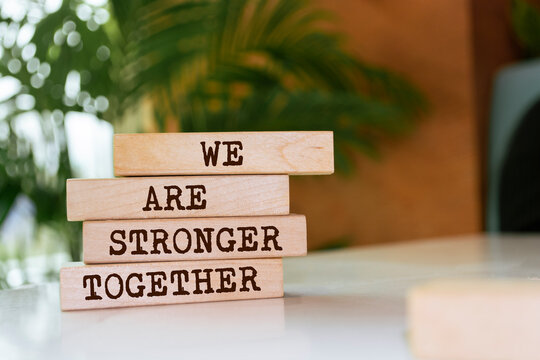 Wooden blocks with words 'We are stronger together'. Business concept