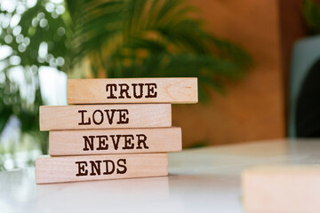 Wooden blocks with words 'True Love Never Ends'.