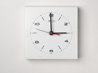 A clock on a white background. It is 3 o'clock. Concept, nobody.
