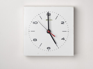 A clock on a white background. It is 5 o'clock. Concept, nobody.	