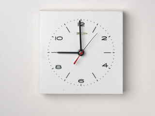 A clock on a white background. It is 9 o'clock. Concept, nobody.

