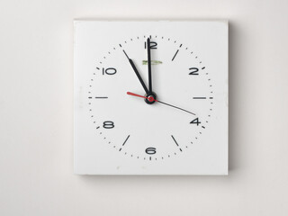 A wall clock isolated on white background. It is 11 o´clock.
