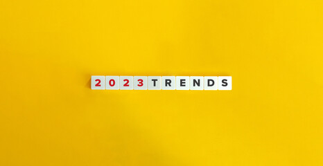 Trends for 2023 concept. Letter tiles on bright orange background. Minimal aesthetics.