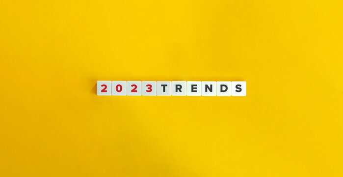 Trends for 2023 concept. Letter tiles on bright orange background. Minimal aesthetics.