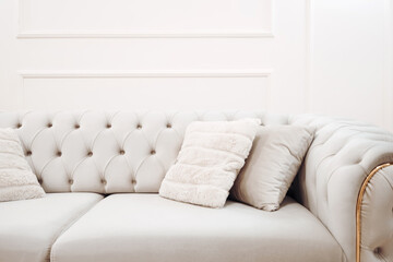 Stylish sofa, details of couch fabric and pillows. Boho design, comfortable sofa with textures and modern furniture