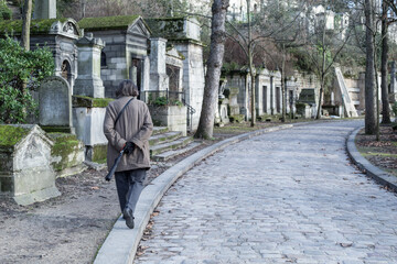 person walking in the cemetery 