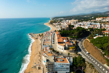Obraz premium Aerial photo of Spanish municipality Sant Pol de Mar with view of beach and residential buildings.