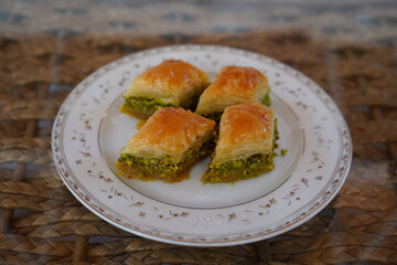 Baklava slices, 4 baklava slices on a white plate. Turkish baklava is made in Gaziantep