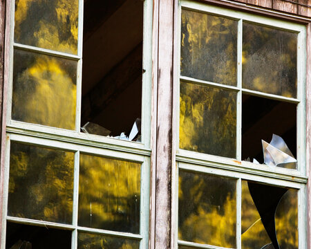 Reflections in broken windows at Lairds Landing, Tomales Bay, Point Reyes National Seashore, CA.
