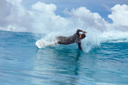 Male surfer riding wave, Male, Maldives