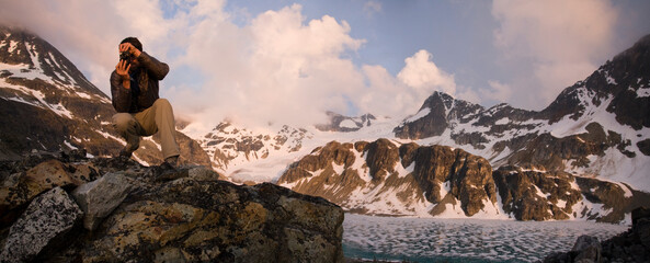 A young man takes pictures at Wedgemount Lake, Garibaldi Provincial Park, British Columbia, Canada.