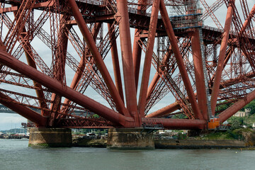 Base of the iconic Forth Bridge showing the circular pier foundation supports for the double...