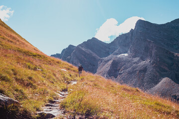 Hiker on the way in the Alps Mountains
