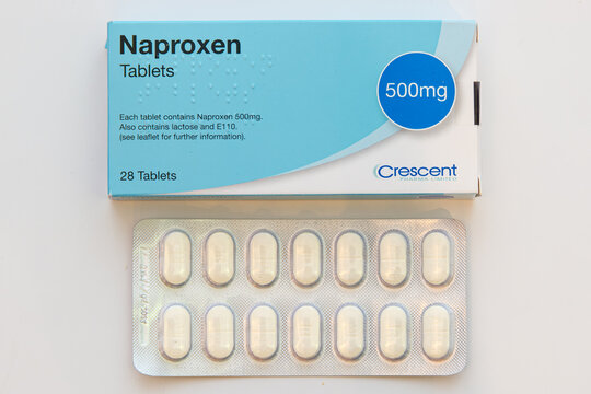 Box and blister pack of generic Crescent 500mg Naproxen tablets on white background