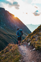 Obraz premium Hiker in the Alps Mountains in the sunset