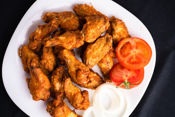 Hot chicken wings with honey and parmeisane cheese